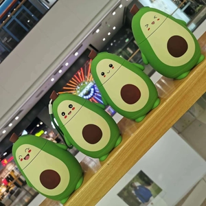 Close-up of four cute avocado silicone covers with different cartoon expressions