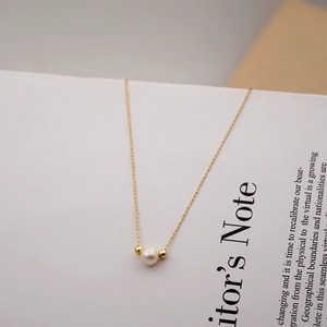 Minimalist freshwater pearl pendant necklace on titanium steel chain in golden finish