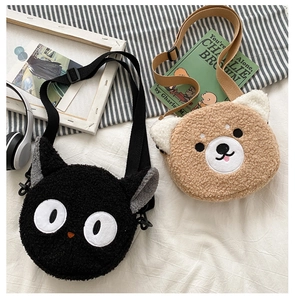 Detail of plush lambskin-textured round bags with cute cat and bear doll designs