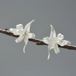 Handcrafted S925 sterling silver iris flower stud earrings on a natural branch