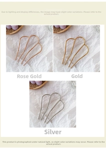 Close-up of minimalist M-shaped metal hair forks in rose gold, gold, and silver finishes