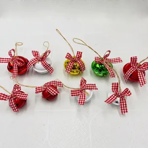 Festive Christmas metal bells with buffalo plaid bows and twine loops in various colors