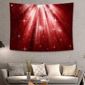 Detail of red Christmas tapestry with starburst pattern hanging over a modern gray sofa