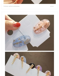 Detail view of colorful acetate cat hair clips showing resin patterns and metal bases