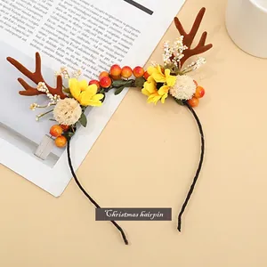 Christmas reindeer antler headband with sunflowers and berries on a decorative table