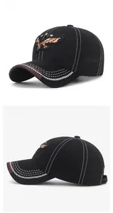 Detail of eagle embroidery and contrast wave stitching on a black baseball cap