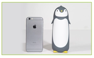 Size comparison of a penguin-shaped vacuum flask next to an iPhone for scale