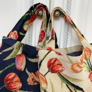 Detail of vintage tulip jacquard fabric texture on small hand-woven tote bags