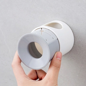 Wall-mounted electric toothbrush holder with flexible silicone insert and adhesive base