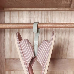 Rotating four-claw hook hanger in light grey-green for organizing shoes and scarves