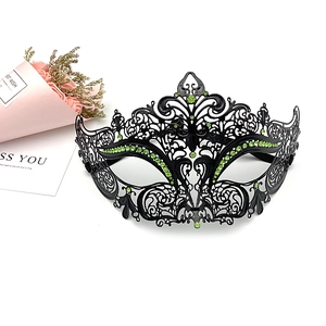Intricate black metal masquerade mask with green rhinestones shown with floral accents