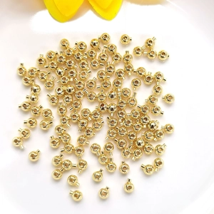 14K gold filled spacer beads for DIY jewelry making laid flat on a white background