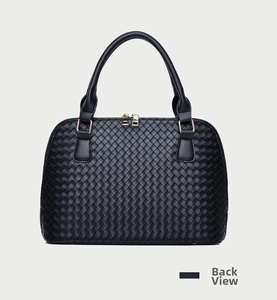Back view of black woven shell handbag showing detailed cross-weave texture and golden hardware