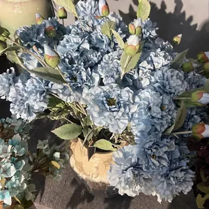 Three-headed artificial blue peonies in a ceramic vase for wedding and home decoration