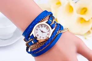 Detail of bohemian wrap watch with blue woven leather bands and golden metal chains