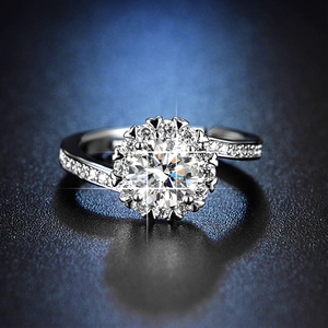 Macro shot of silver six-prong halo ring with brilliant round cut diamond solitaire
