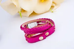 Detail of fuchsia woven wrap watch with gold chains and stainless steel back case