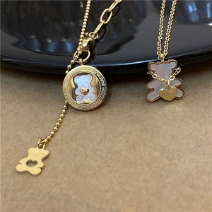 Golden stainless steel bear pendant necklace featuring white mother of pearl inlay detail