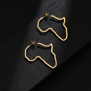 Detailed close-up of gold stainless steel Africa map earrings on a black leather background