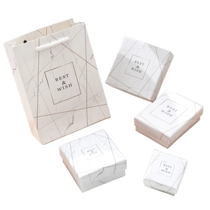 Elegant marble pattern jewelry gift box set with golden lines and matching paper bags