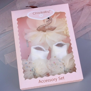 Detailed gift set featuring a mesh swan headband and bow socks in a pink display box