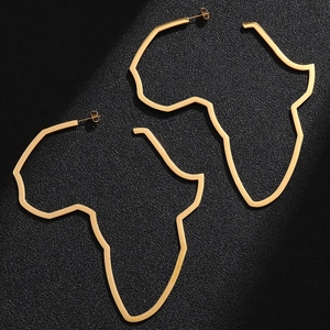 Detailed view of large gold African map hollow hoop earrings with polished metal finish