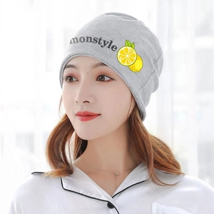 Detailed close-up of a grey knit maternity hat with Monstyle lettering and lemon pattern