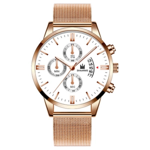 Macro shot of rose gold mesh band watch with a white dial and date window detail