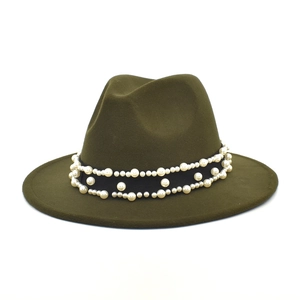 Detail of dark olive wool fedora hat featuring black band with elegant white pearl accents