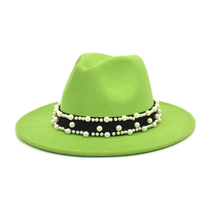 Detail view of the bright green wool fedora hat with elegant pearl-beaded black ribbon band