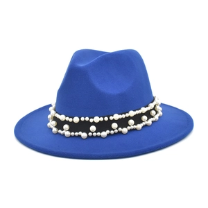 Detail of royal blue wool fedora hat featuring pearl embellishments and black ribbon trim