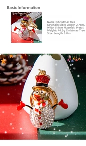 Detailed view of rhinestone snowman keychain with size specs and Christmas pinecone decor