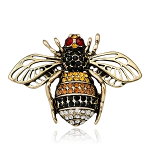 Detailed view of a gold bee brooch featuring colorful rhinestones and hollow wings