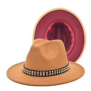 Detail of wool fedora hat featuring double-row metal studs and contrast red lining