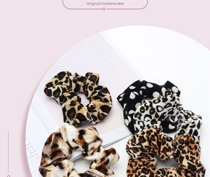 Detail showing elastic animal print scrunchies in leopard and zebra patterns on a magazine