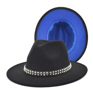 Detail of black fedora with blue lining and gold square studs on the decorative band