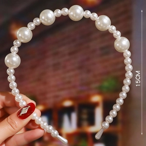 Detail showing various sizes of white faux pearls on a 15cm diameter bridal headband