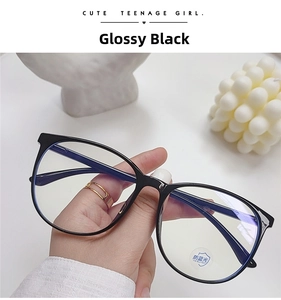 Handheld detail of large black anti-blue light glasses with glossy finish on white background