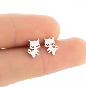 Detailed close-up showing compact size of minimalist silver cat stud earrings in hand