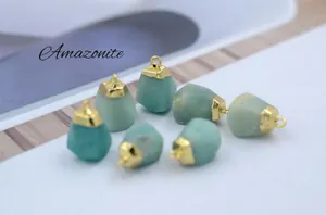 Macro detail of natural amazonite stone pendants with golden metal caps and textured surface