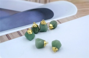 Detailed view of six raw green aventurine stone pendants with gold metal hooks for DIY jewelry