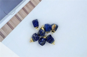 Deep blue lapis lazuli raw stone pendants with gold metal edges and hanging loops