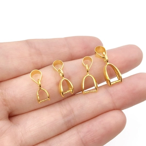 Detailed comparison of four sizes of gold-plated copper pendant bails on a fingertip