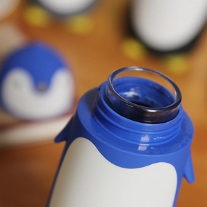Cute penguin insulated glass water bottle with blue and white cartoon lid design