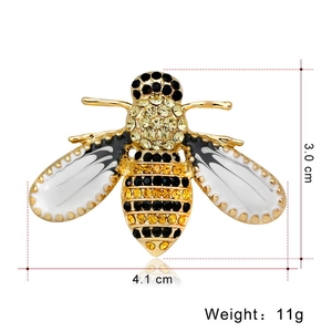 Macro shot of bee brooch with gold plating, amber crystals and enamel wings, 4.1cm x 3.0cm