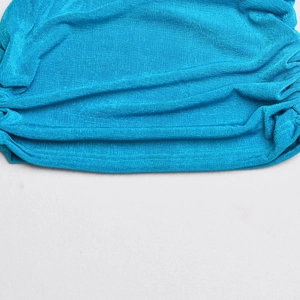 Detailed macro view of the blue textured fabric featuring elegant pleated design details