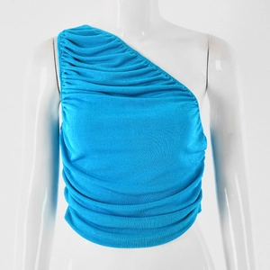 Close-up detail of blue one-shoulder top featuring textured pleated fabric on mannequin
