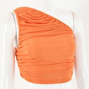 Detail showing orange one-shoulder cropped top with elegant pleated fabric texture