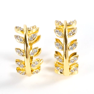 Elegant gold leaf hoop earrings with shimmering cubic zirconia accents on white background