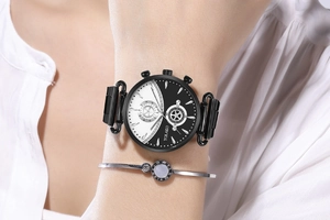Detail of YOLAKO women's watch with black and white split dial and matching silver bangle